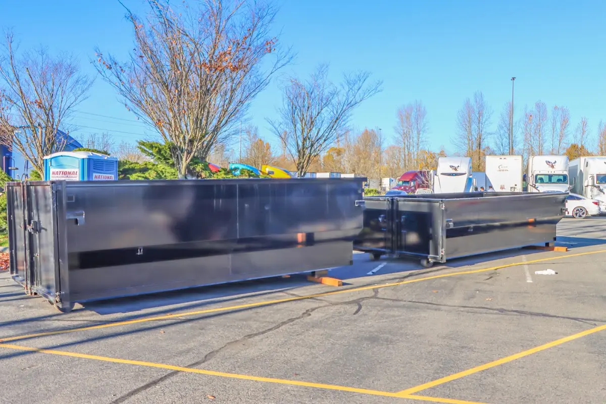 Professional dumpster rental service with roll-off container on residential driveway in Dry Run